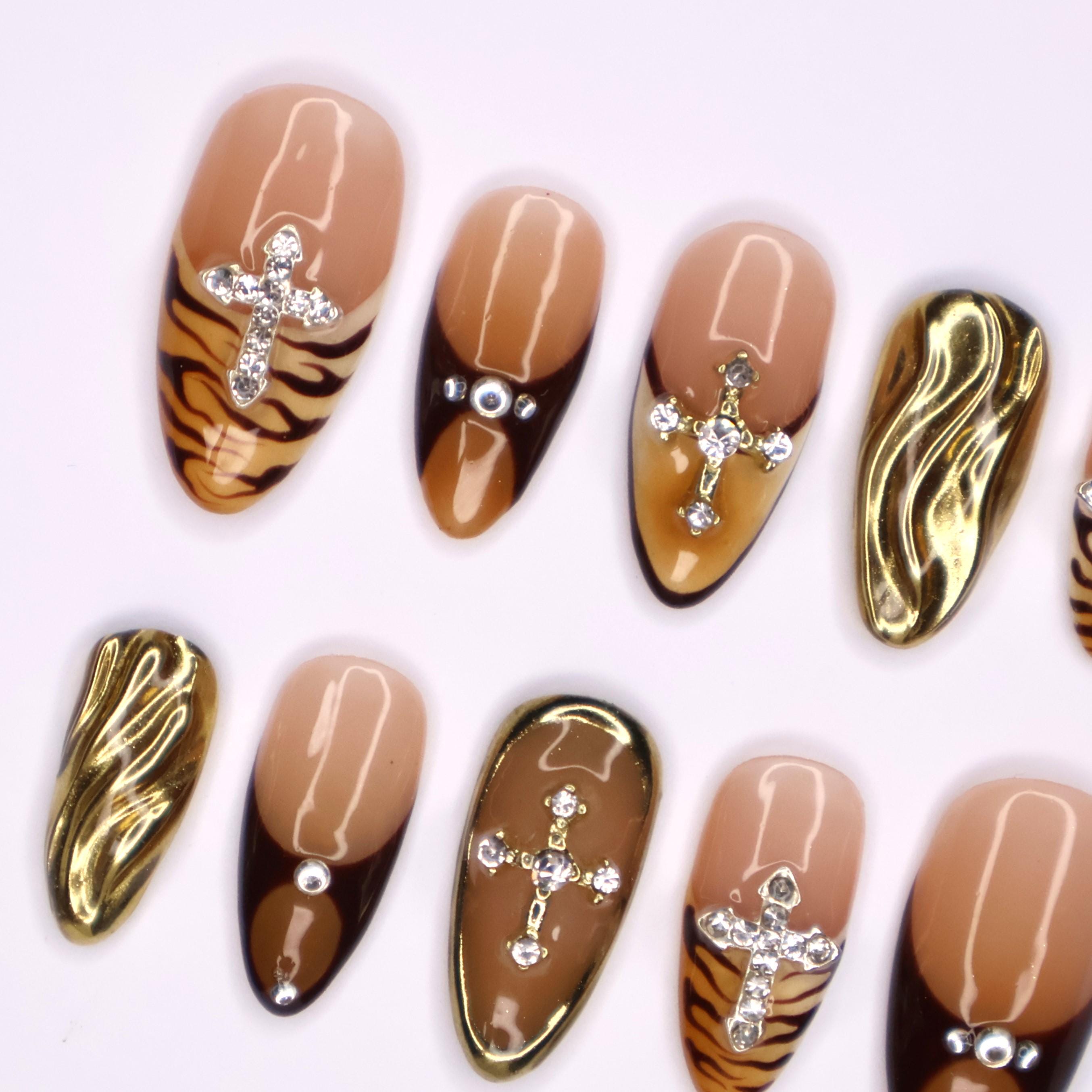 Fierce Fall Vibes, French Tips Meet Wild Tiger Print with 3D Gel Chrome Gold Cross and Dazzling Gems - Perfect for Your Autumn Style