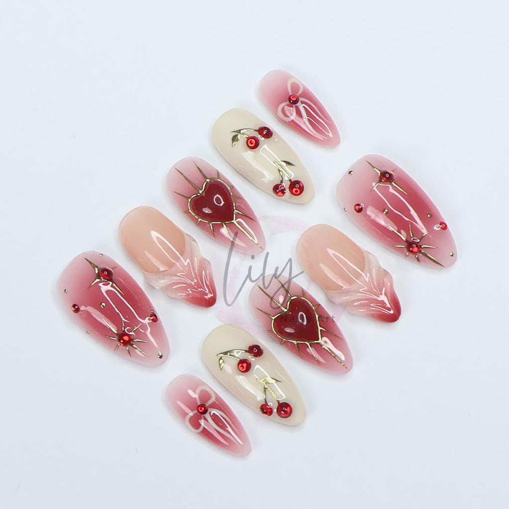 Elevate your nail with Red Aura Press-On Nails, featuring 3D gel hearts and cherries in medium almond, perfect for gifting or everyday glam