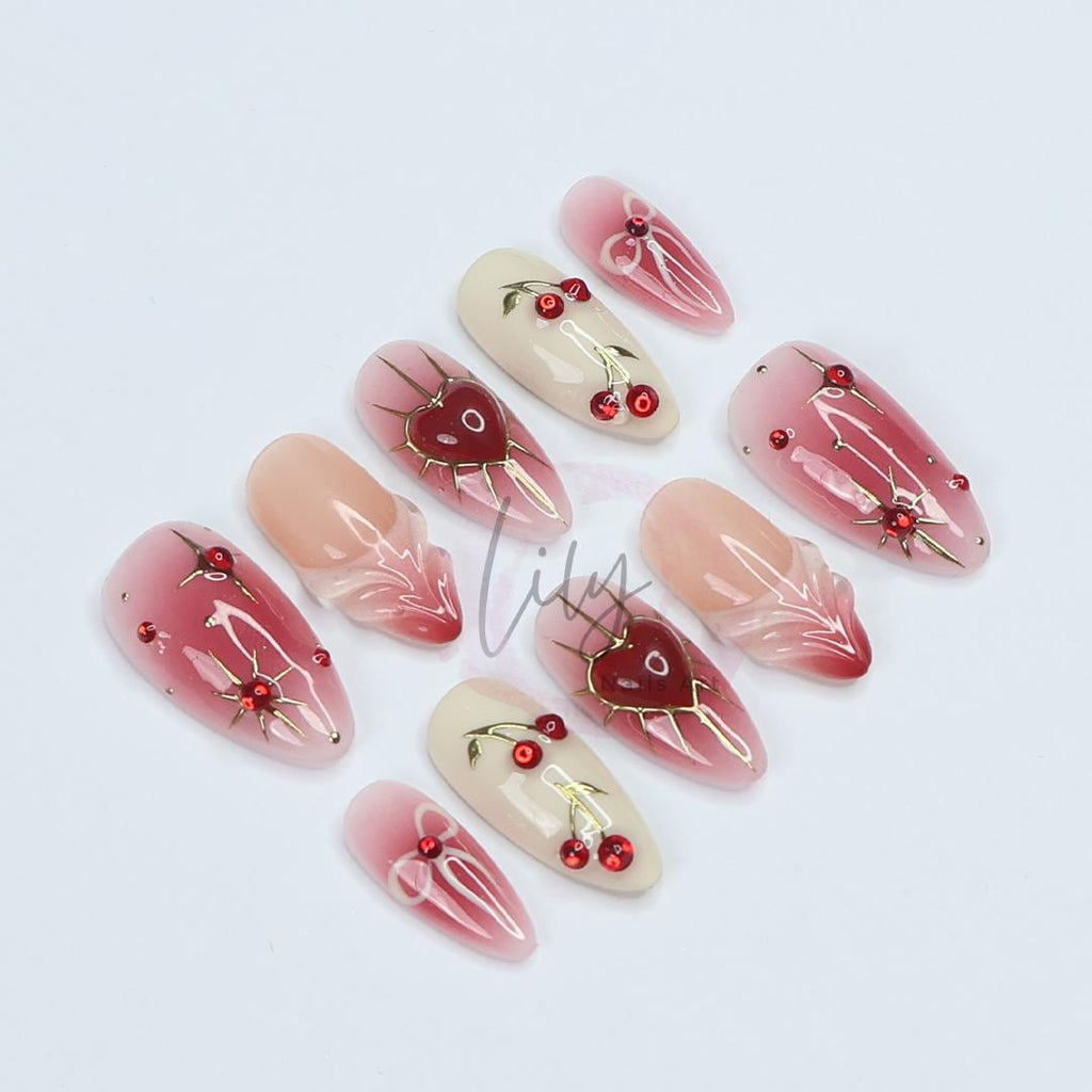 Elevate your nail with Red Aura Press-On Nails, featuring 3D gel hearts and cherries in medium almond, perfect for gifting or everyday glam