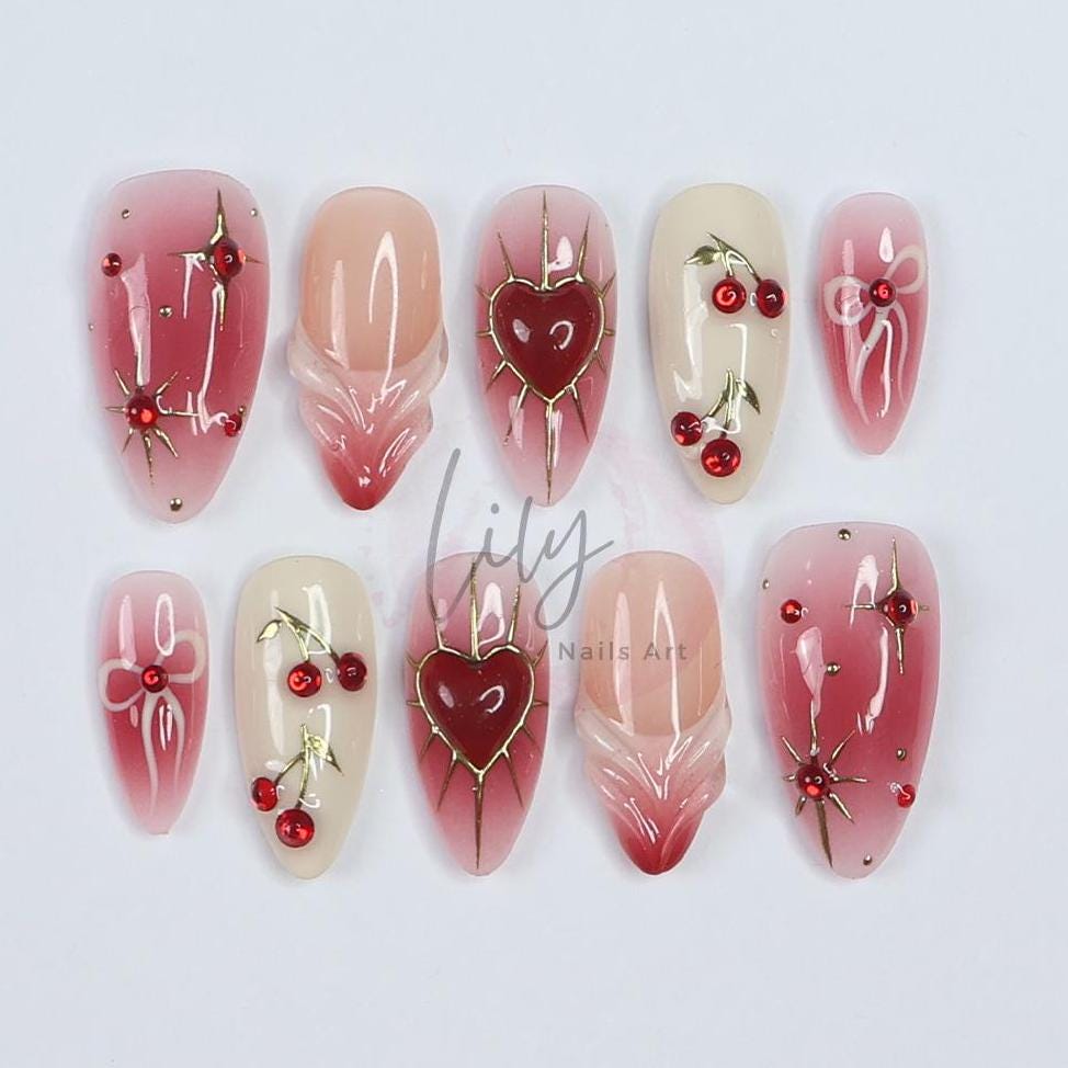 Elevate your nail with Red Aura Press-On Nails, featuring 3D gel hearts and cherries in medium almond, perfect for gifting or everyday glam