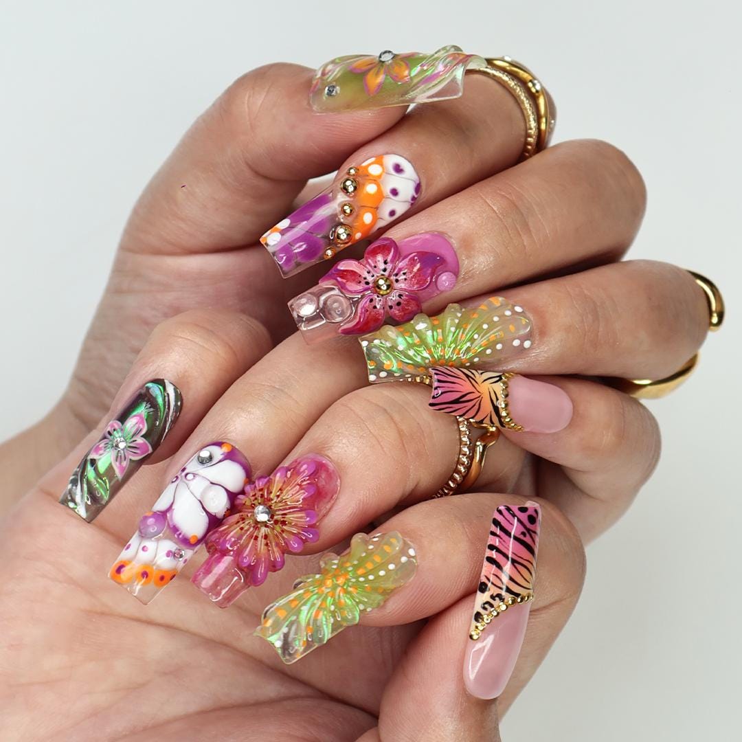 Vibrant spring press-on nails with 3D flowers, butterfly wings & animal print, perfect for birthdays, vacations or a unique gift for her