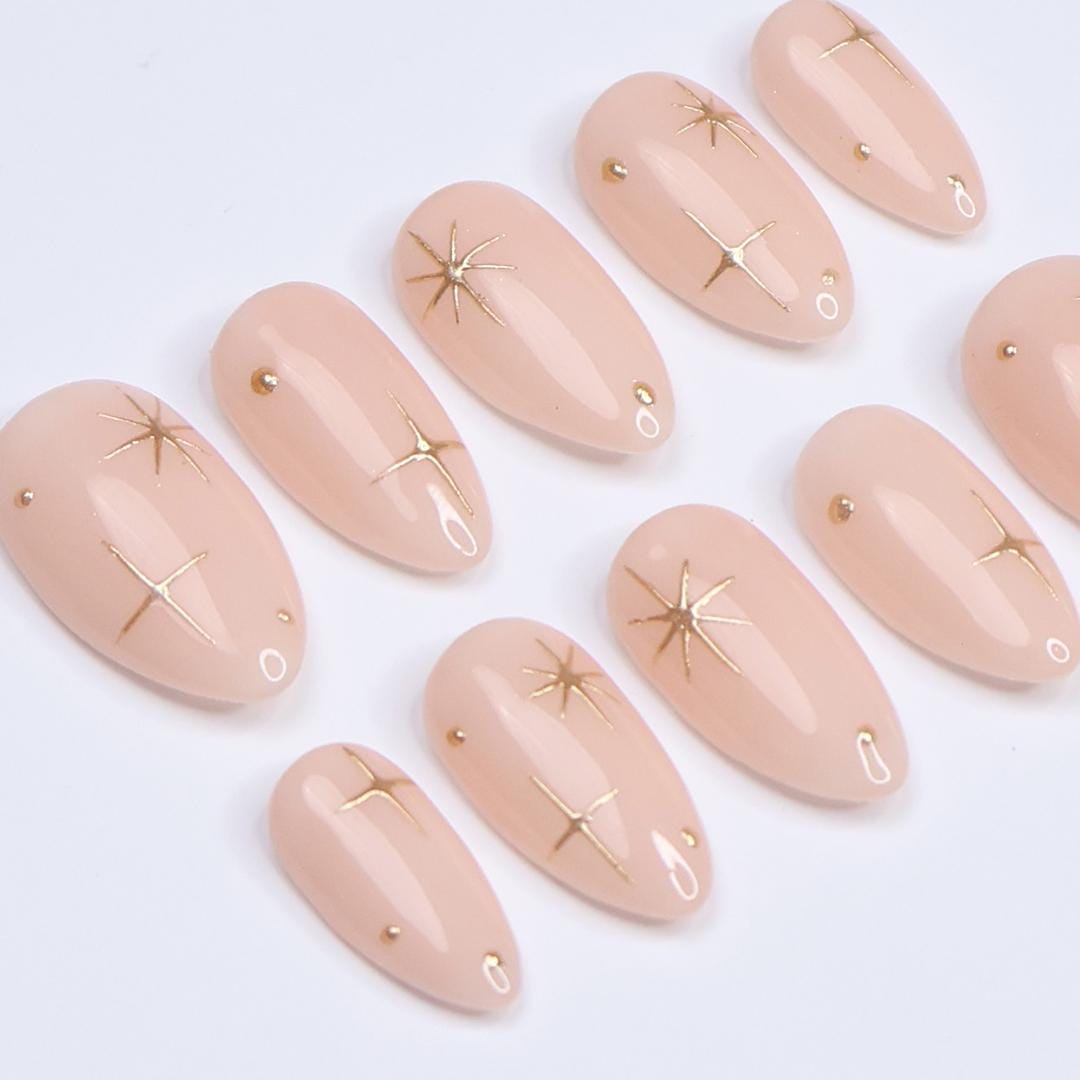 Minimal Press on Nail Gold Starburst with Nude Base | Everyday Fake Nail Art in Short Almond | Handmade Nail Art for Holiday, Birthday, Trip
