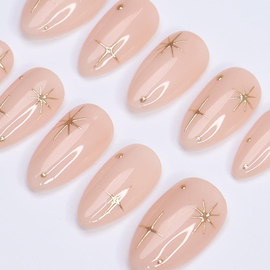 Minimal Press on Nail Gold Starburst with Nude Base | Everyday Fake Nail Art in Short Almond | Handmade Nail Art for Holiday, Birthday, Trip