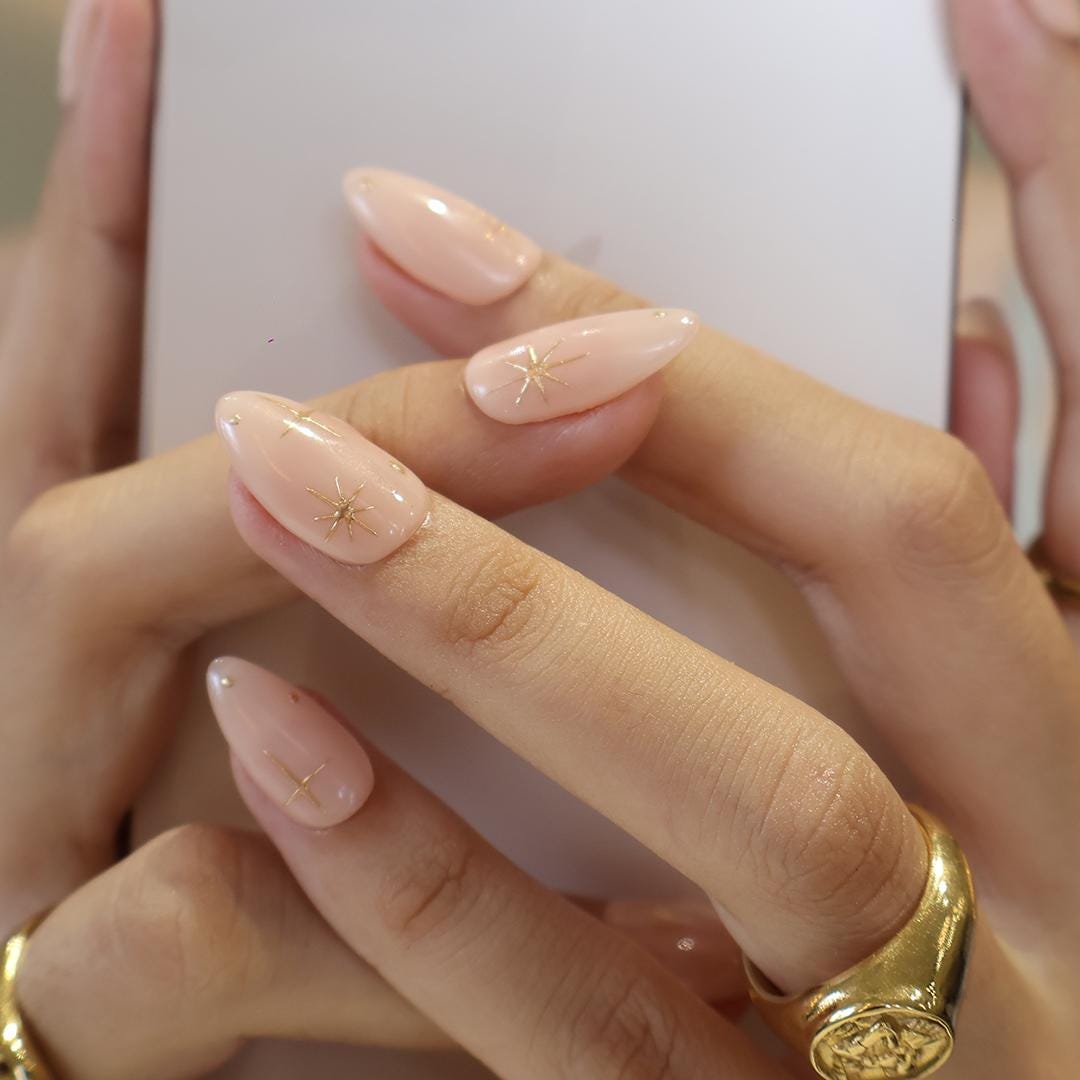 Minimal Press on Nail Gold Starburst with Nude Base | Everyday Fake Nail Art in Short Almond | Handmade Nail Art for Holiday, Birthday, Trip