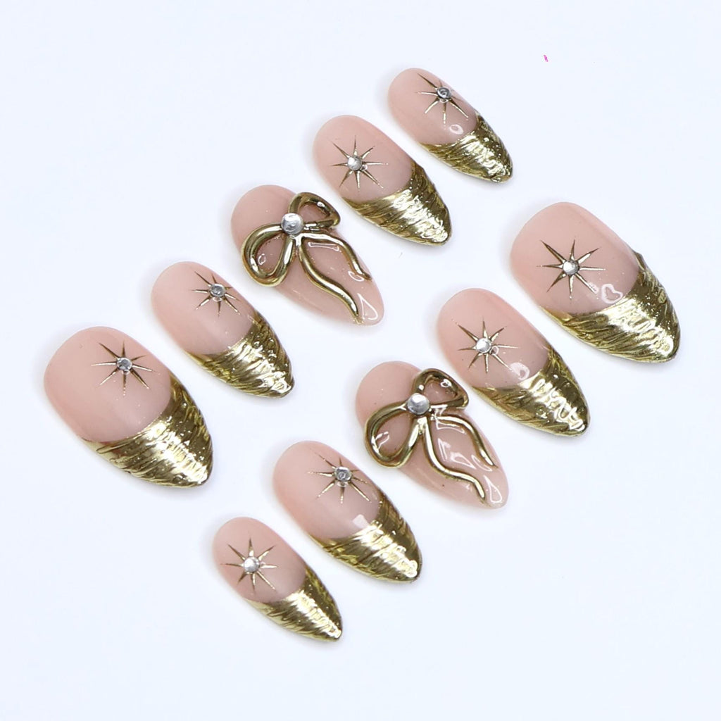 Gold Press On Nails | Nude Base with Gold Bow & Star Design | Medium Almond Fake Nails | Handmade Nail Art for Everyday Wear